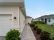 The side of the house shows a brick pathway, garage, and garden at 17857 Woodland Ct, Punta Gorda, FL 33982