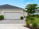 Charming home featuring a two-car garage with brick paver driveway and beautifully landscaped front yard at 17857 Woodland Ct, Punta Gorda, FL 33982