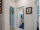 Hallway view of a bathroom with shower tub and a coastal themed bedroom at 17857 Woodland Ct, Punta Gorda, FL 33982