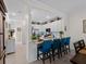 Open kitchen with bar seating featuring granite counters, stainless appliances and white cabinets at 17857 Woodland Ct, Punta Gorda, FL 33982