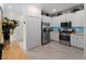 Well-lit kitchen boasts stainless steel appliances, white cabinets, and a view of the dining area at 17857 Woodland Ct, Punta Gorda, FL 33982