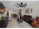 Spacious living room features leather couches, large ceiling fan, and open floor plan at 17857 Woodland Ct, Punta Gorda, FL 33982