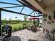 Covered lanai with a dining table and outdoor grill at 17857 Woodland Ct, Punta Gorda, FL 33982