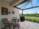 View of the covered lanai with view of the backyard at 17857 Woodland Ct, Punta Gorda, FL 33982