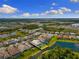 Home with a pool and water view of a lake and lush landscaping at 19821 Montenero Way, Venice, FL 34293