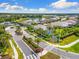 An aerial view shows a well-maintained community, with lush landscaping and a serene lake at 19821 Montenero Way, Venice, FL 34293