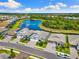 Beautiful aerial view of houses, lake, and landscaping at 19821 Montenero Way, Venice, FL 34293