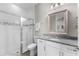 Bathroom with a glass-enclosed shower and a granite vanity at 19821 Montenero Way, Venice, FL 34293