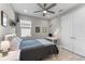 Cozy bedroom with a ceiling fan, a window, and gray walls at 19821 Montenero Way, Venice, FL 34293