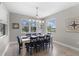 Cozy dining room with nautical decor, wooden floors, and plenty of natural light creating an inviting space at 19821 Montenero Way, Venice, FL 34293