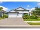 Charming two-story home with a three-car garage and a beautifully landscaped front yard at 19821 Montenero Way, Venice, FL 34293