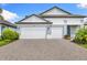 Attractive home with a three-car garage, showcasing its appealing architecture and pristine driveway at 19821 Montenero Way, Venice, FL 34293