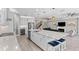 Open-concept kitchen with a large island, flowing into the living area, perfect for entertaining and Gathering gatherings at 19821 Montenero Way, Venice, FL 34293