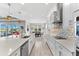 Gourmet kitchen with a large island, modern appliances, and a seamless flow to the dining area at 19821 Montenero Way, Venice, FL 34293