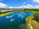 Aerial view of lake with lush landscaping at 19821 Montenero Way, Venice, FL 34293