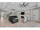 Spacious living room with modern decor, a cozy fireplace, and stylish furnishings perfect for relaxation and gatherings at 19821 Montenero Way, Venice, FL 34293