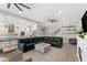 Open-concept living room flowing into kitchen with a large sectional couch at 19821 Montenero Way, Venice, FL 34293