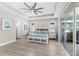 Bright primary bedroom with a tray ceiling and sliders leading to outdoor space at 19821 Montenero Way, Venice, FL 34293