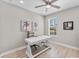 Bright office with a ceiling fan, a large window, and a white desk at 19821 Montenero Way, Venice, FL 34293
