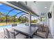 Spacious screened-in patio featuring a dining area and seating, perfect for outdoor enjoyment at 19821 Montenero Way, Venice, FL 34293