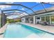 Screened pool, spa, outdoor seating, and dining area showcasing the backyard oasis at 19821 Montenero Way, Venice, FL 34293