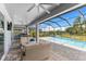 Screened-in pool area featuring an outdoor seating area and a tranquil lake view at 19821 Montenero Way, Venice, FL 34293