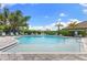Community pool with plenty of lounge chairs and a beautiful blue sky at 19821 Montenero Way, Venice, FL 34293