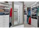 Well-organized walk-in closet with shelving and mirror leading to ensuite at 19821 Montenero Way, Venice, FL 34293