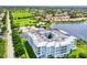 Aerial view of the condo building overlooking the golf course, with water views at 2001 Bal Harbor Blvd # 2306, Punta Gorda, FL 33950