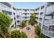 Three story courtyard with a fountain, decorative brick, and stairs to each floor at 2001 Bal Harbor Blvd # 2306, Punta Gorda, FL 33950