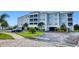 Beautiful condominium exterior showcasing well-maintained landscaping and ample parking at 2001 Bal Harbor Blvd # 2306, Punta Gorda, FL 33950