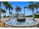 Stunning fountain surrounded by palm trees and beautiful landscaping in front of the condos at 2001 Bal Harbor Blvd # 2306, Punta Gorda, FL 33950