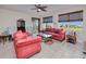 Living room with a ceiling fan, water views, and decorative window shades at 2001 Bal Harbor Blvd # 2306, Punta Gorda, FL 33950