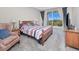 Comfortable main bedroom features a balcony, soft carpet, and a stylish chair for relaxing at 2001 Bal Harbor Blvd # 2306, Punta Gorda, FL 33950