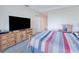 Spacious main bedroom with soft carpet, a large TV, and stylish, comfortable furnishings at 2001 Bal Harbor Blvd # 2306, Punta Gorda, FL 33950