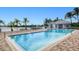 Inviting community pool area with lounge chairs, tables and clubhouse overlooking the water at 2001 Bal Harbor Blvd # 2306, Punta Gorda, FL 33950
