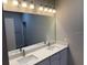 Well-lit bathroom featuring a double vanity with modern fixtures and a large mirror at 207 Baytree Dr, Rotonda West, FL 33947