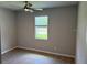 Neutral bedroom with a ceiling fan, window with blinds, and laminate flooring at 207 Baytree Dr, Rotonda West, FL 33947