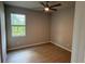 Minimalist bedroom featuring a ceiling fan, a window, and neutral wall colors at 207 Baytree Dr, Rotonda West, FL 33947