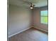 Bedroom featuring a ceiling fan, laminate floors, and window with natural light at 207 Baytree Dr, Rotonda West, FL 33947