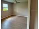 Cozy bedroom featuring a ceiling fan, a window, and neutral wall colors at 207 Baytree Dr, Rotonda West, FL 33947