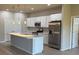 Modern kitchen featuring stainless steel appliances, a center island, and sleek white cabinetry at 207 Baytree Dr, Rotonda West, FL 33947