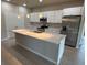 Well-lit kitchen featuring a spacious island, stainless steel appliances, and modern cabinets at 207 Baytree Dr, Rotonda West, FL 33947