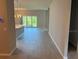 Open-concept living space with sliding glass doors and neutral walls at 207 Baytree Dr, Rotonda West, FL 33947