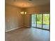 Bright living room with sliding glass doors opening to the outdoors and a modern chandelier at 207 Baytree Dr, Rotonda West, FL 33947