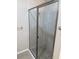 Modern glass enclosed shower with pebble floor and brushed metal fixtures at 207 Baytree Dr, Rotonda West, FL 33947