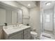 Modern bathroom with gray vanity, a marbled countertop, and glass-enclosed shower at 219 Tait Se Ter, Port Charlotte, FL 33952