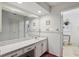 Bright bathroom with large mirror and vanity providing ample counter space at 219 Tait Se Ter, Port Charlotte, FL 33952