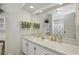 Bright bathroom features a white vanity, decorative towels and a large mirror reflecting the shower at 219 Tait Se Ter, Port Charlotte, FL 33952