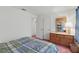 Cozy bedroom with wood dresser, mirror, and a comfortable-looking blue and green plaid comforter at 219 Tait Se Ter, Port Charlotte, FL 33952